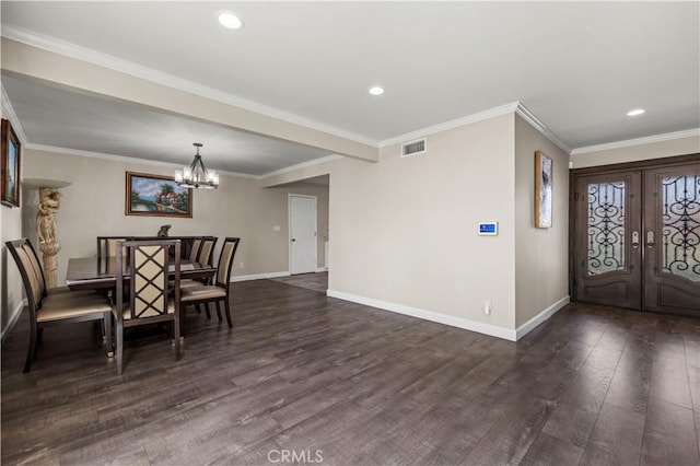 entryway featuring an inviting chandelier, dark hardwood / wood-style floors, ornamental molding, and french doors