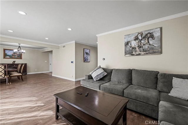 living room featuring ornamental molding, hardwood / wood-style floors, and a chandelier