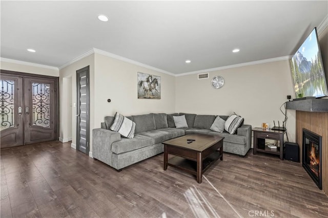 living room featuring crown molding, hardwood / wood-style floors, and french doors