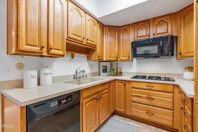 kitchen featuring sink, light tile patterned floors, and black appliances