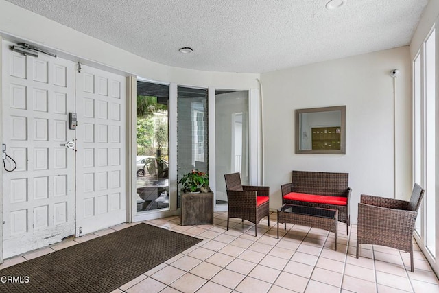 tiled entryway with plenty of natural light and a textured ceiling