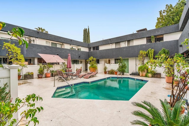 view of swimming pool with a patio area