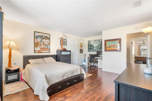 bedroom with dark hardwood / wood-style flooring