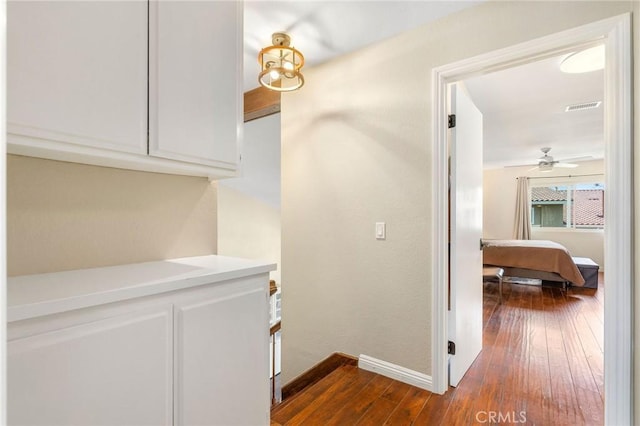 corridor with dark hardwood / wood-style floors