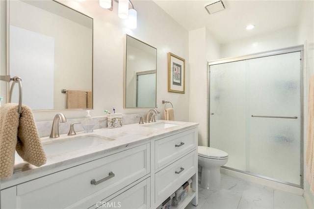 bathroom with vanity, an enclosed shower, and toilet