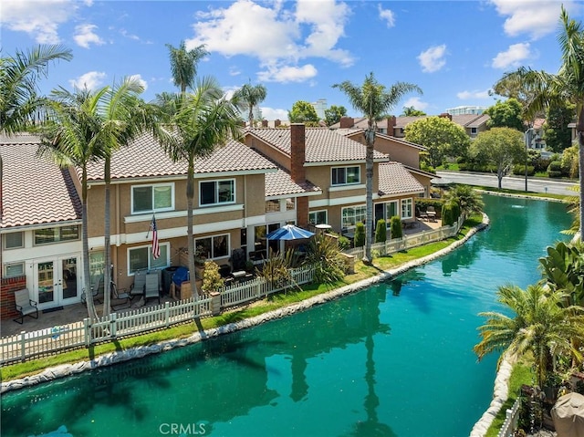 view of pool featuring a water view and french doors