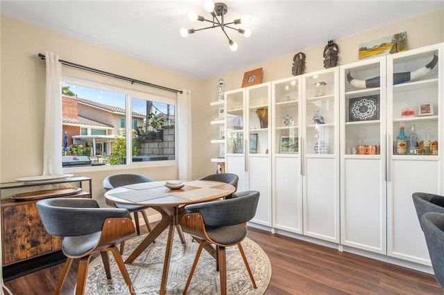 dining space with an inviting chandelier and dark hardwood / wood-style flooring