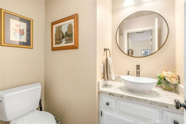 bathroom featuring vanity and toilet