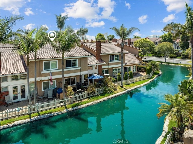 view of pool featuring a water view and french doors