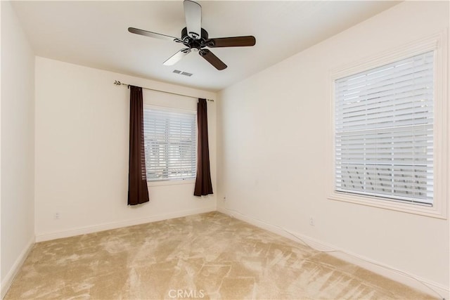 carpeted empty room featuring ceiling fan