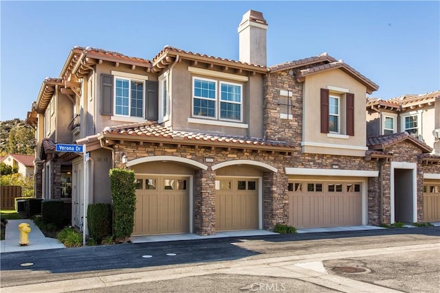 view of front of house with a garage and central AC unit