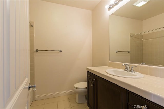 bathroom featuring tile patterned flooring, vanity, and toilet