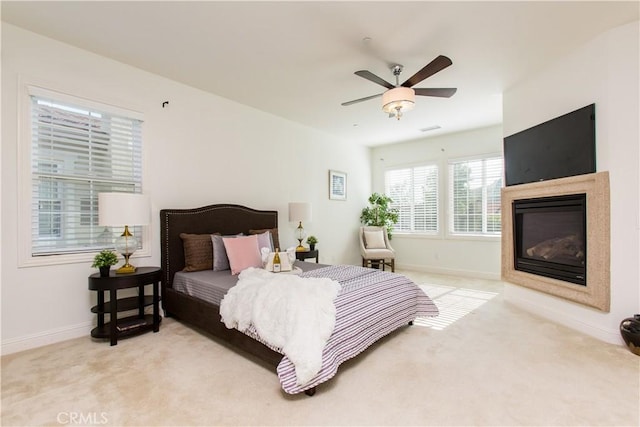 bedroom featuring light carpet and ceiling fan