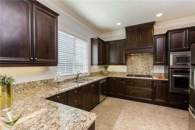 kitchen with sink, ornamental molding, appliances with stainless steel finishes, light stone countertops, and exhaust hood