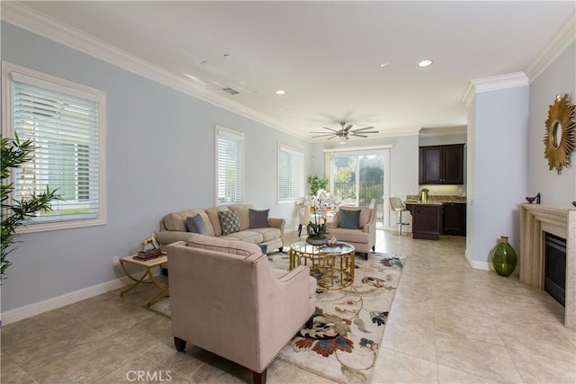 tiled living room with ceiling fan and ornamental molding