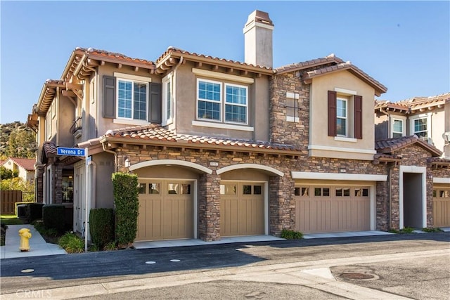 view of front of property with cooling unit and a garage