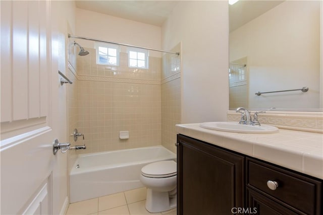 full bathroom with tiled shower / bath combo, vanity, tile patterned floors, and toilet