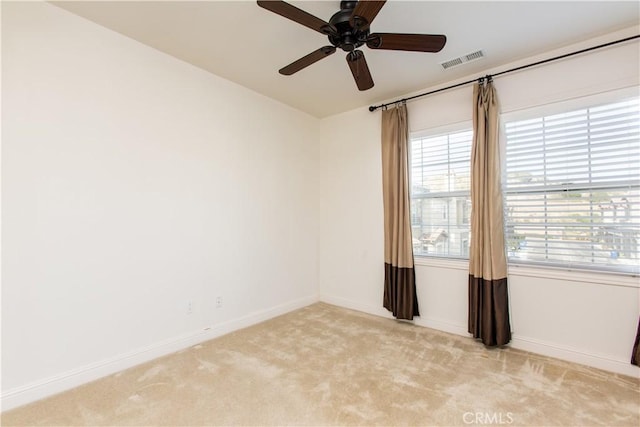 carpeted spare room featuring ceiling fan