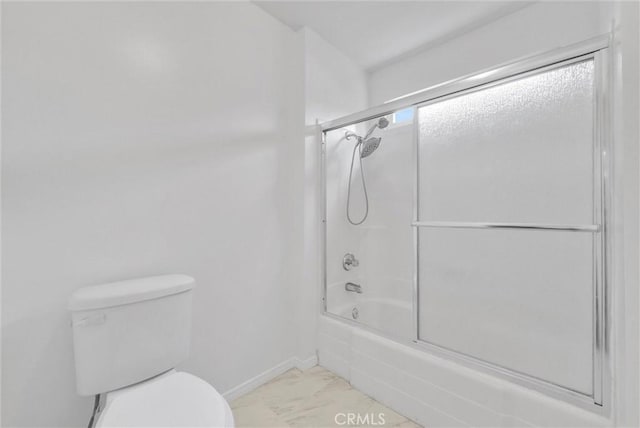 bathroom with bath / shower combo with glass door and toilet