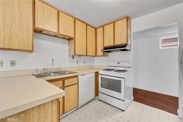 kitchen featuring white appliances, sink, and light brown cabinets