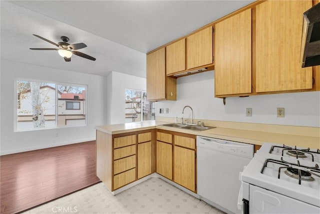 kitchen with ceiling fan, sink, white appliances, and kitchen peninsula