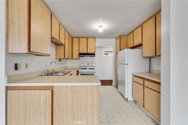 kitchen featuring sink, light brown cabinetry, white appliances, and kitchen peninsula