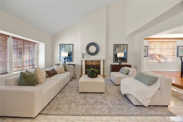 living room featuring light tile patterned flooring and high vaulted ceiling