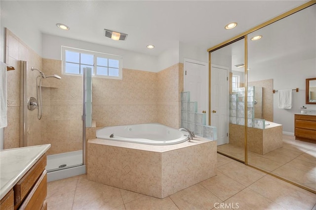 bathroom featuring tile patterned flooring, vanity, and separate shower and tub