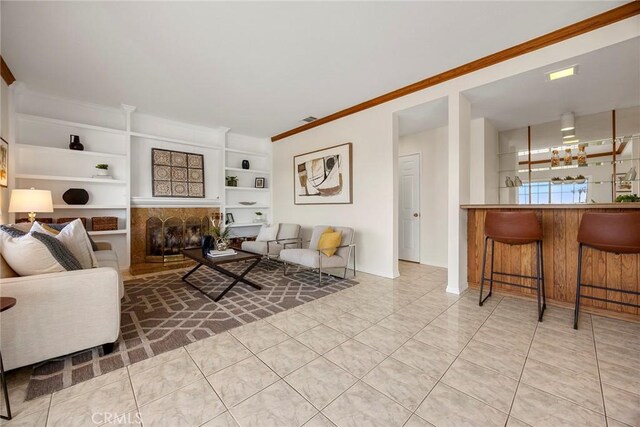 tiled living room with ornamental molding and built in features