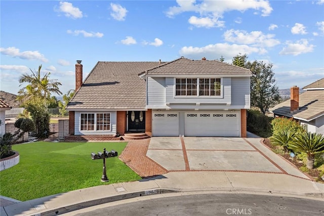 view of front property with a garage and a front yard