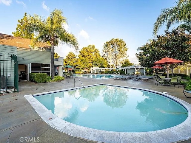 view of swimming pool featuring a patio area