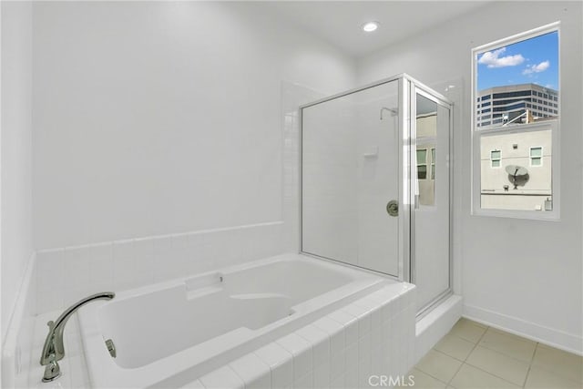 bathroom featuring tile patterned flooring and plus walk in shower