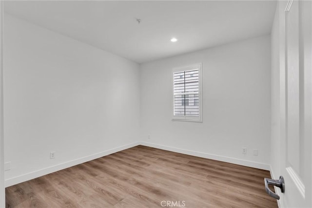 unfurnished room with wood-type flooring