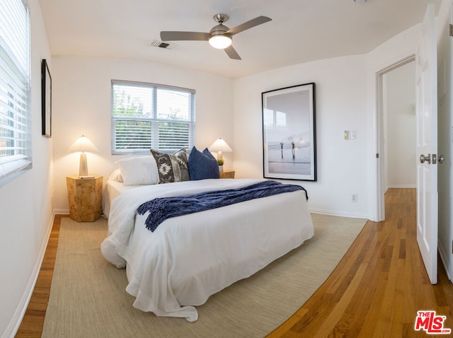 bedroom with ceiling fan and light hardwood / wood-style flooring