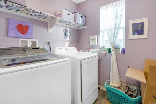 laundry room featuring hardwood / wood-style flooring and washing machine and clothes dryer