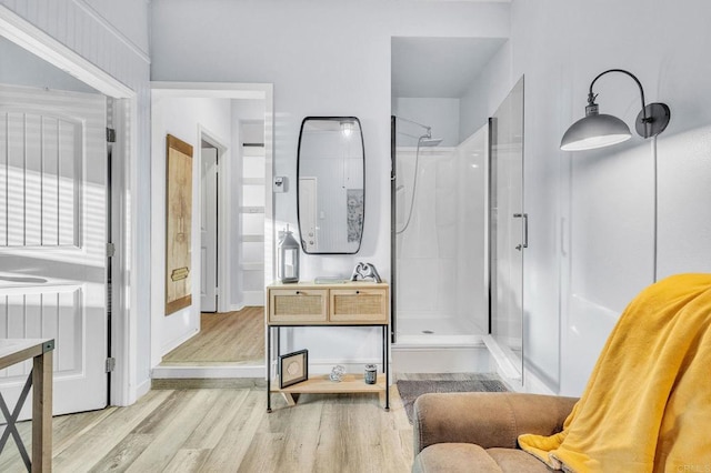 bathroom featuring wood-type flooring, vanity, and a shower