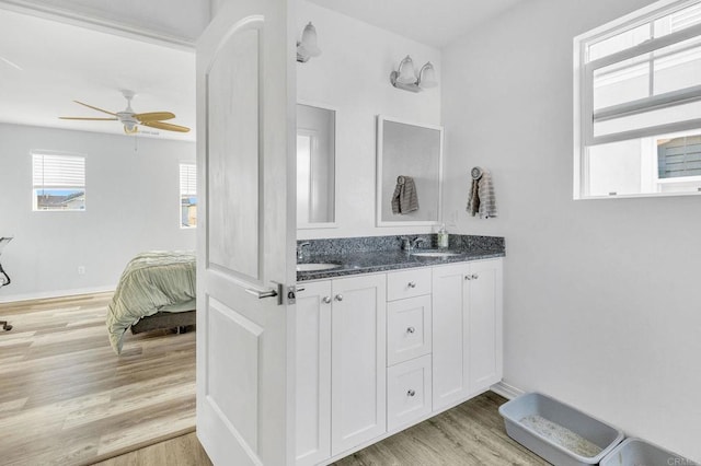 bathroom featuring ceiling fan, vanity, and wood-type flooring