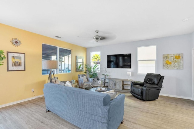 living room with ceiling fan and light hardwood / wood-style flooring