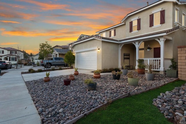 view of front of property with a garage and a porch