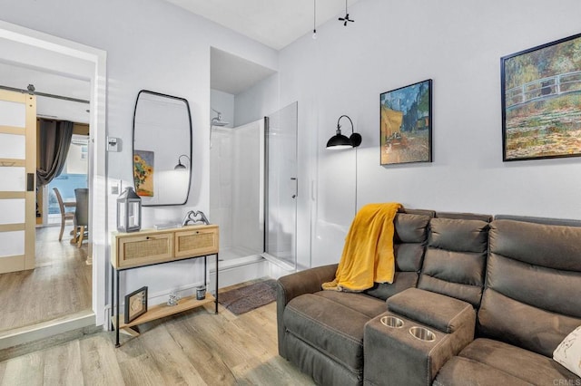 living room featuring a barn door and light wood-type flooring