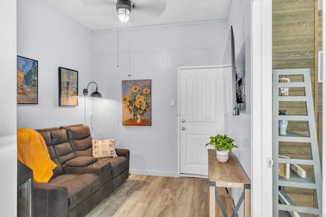 living room with ceiling fan and light hardwood / wood-style flooring