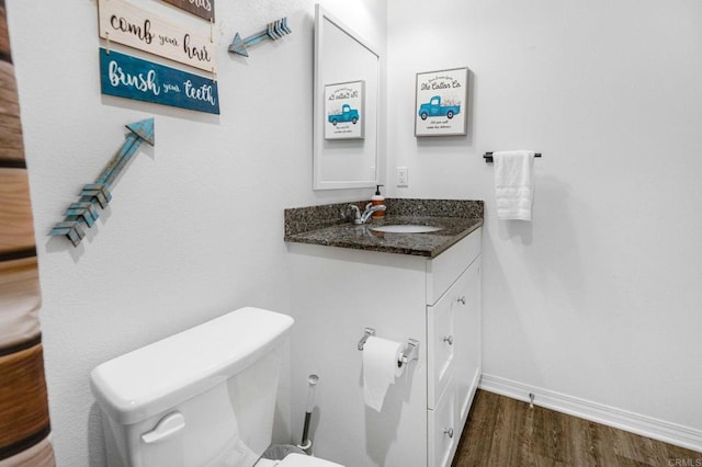 bathroom featuring vanity, toilet, and hardwood / wood-style floors