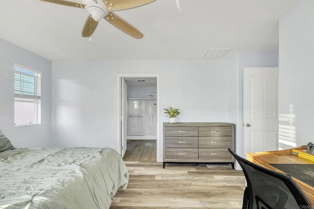 bedroom featuring ensuite bathroom, ceiling fan, and light wood-type flooring