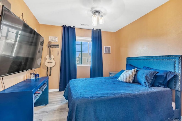 bedroom with light hardwood / wood-style flooring and ceiling fan