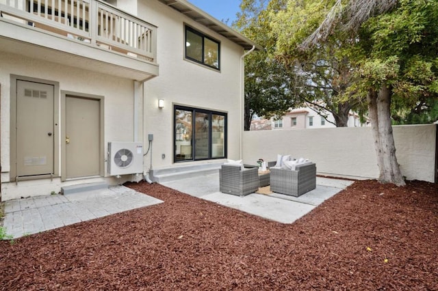 view of patio / terrace with a balcony, an outdoor living space, and ac unit