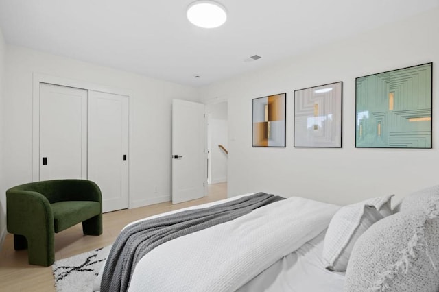 bedroom featuring a closet and light wood-type flooring