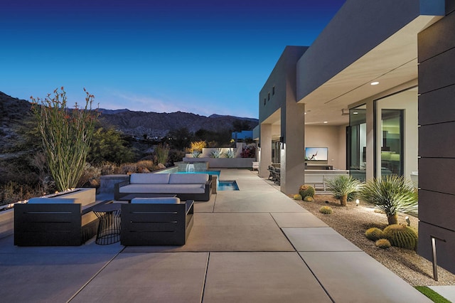 view of patio / terrace with a mountain view, outdoor lounge area, and exterior kitchen