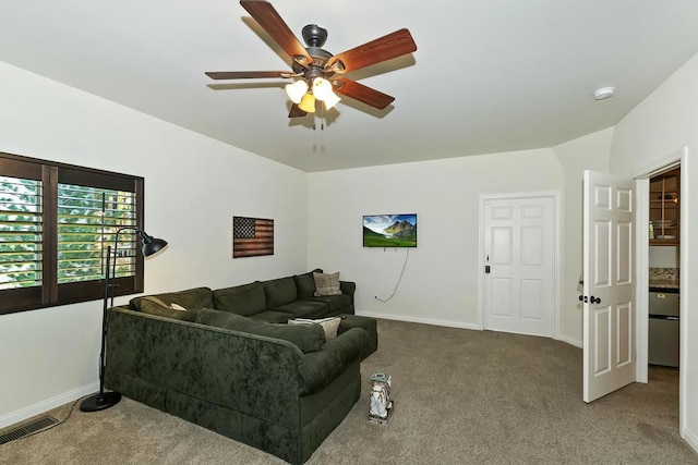 living room with ceiling fan and carpet