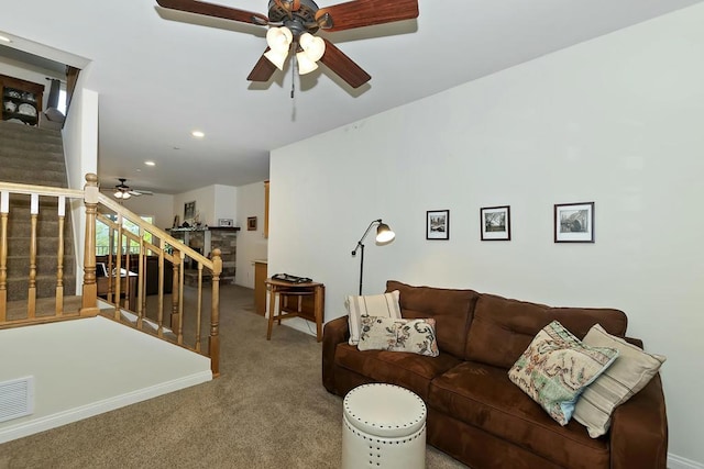 carpeted living room featuring ceiling fan