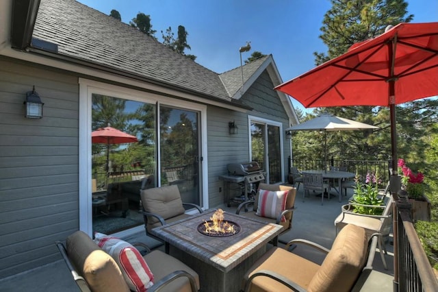 view of patio featuring area for grilling and an outdoor fire pit